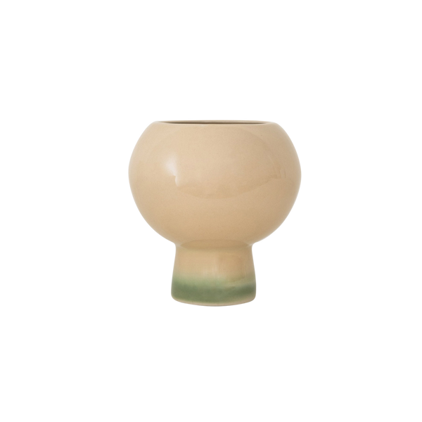 A small ceramic bud vase with a rounded, bulbous body and a short pedestal base, featuring a glossy warm beige finish with a soft green glaze along the bottom edge, set against a plain white background.
