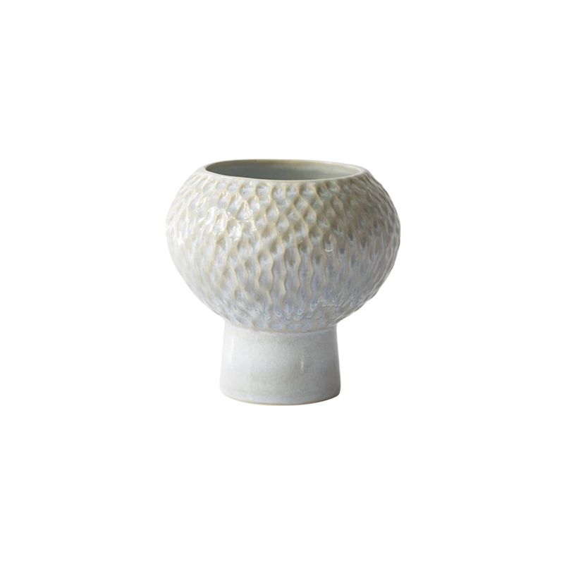 A small ceramic vase with a textured, honeycomb-like patterned body and a flared pedestal base, shown on a plain white background.
