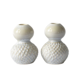 Two small ceramic bud vases with a glossy cream upper bulb and a textured, dimpled lower bulb, shown on a plain white background.